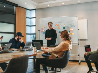 two women and two men having a coffee break in the office 2