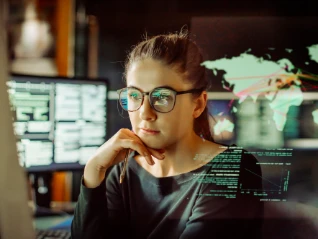 Young female IT worker looking at screen
