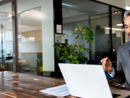 middle aged man taking a business meeting from his laptop