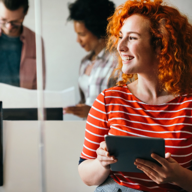 Woman with red hair holding tablet