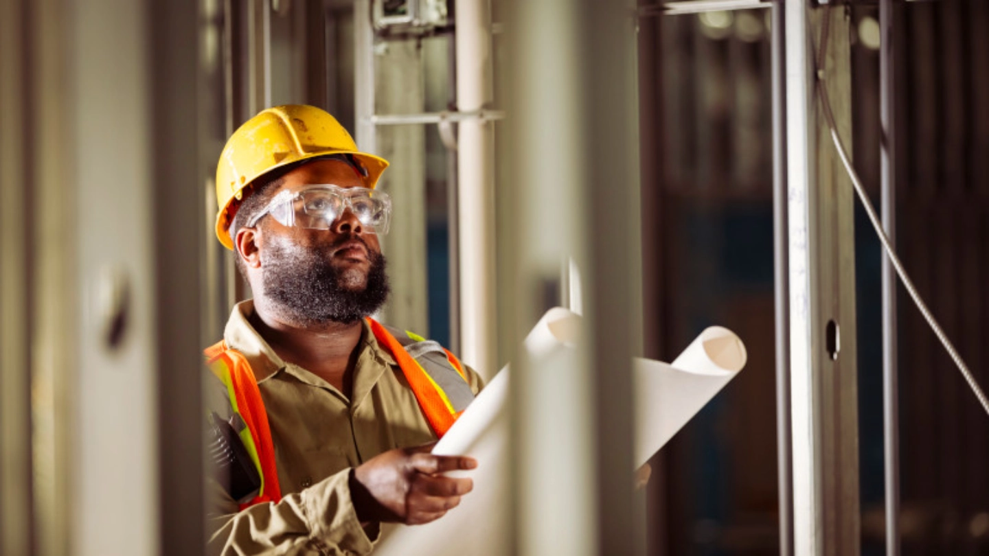 Construction worker reviewing drawings