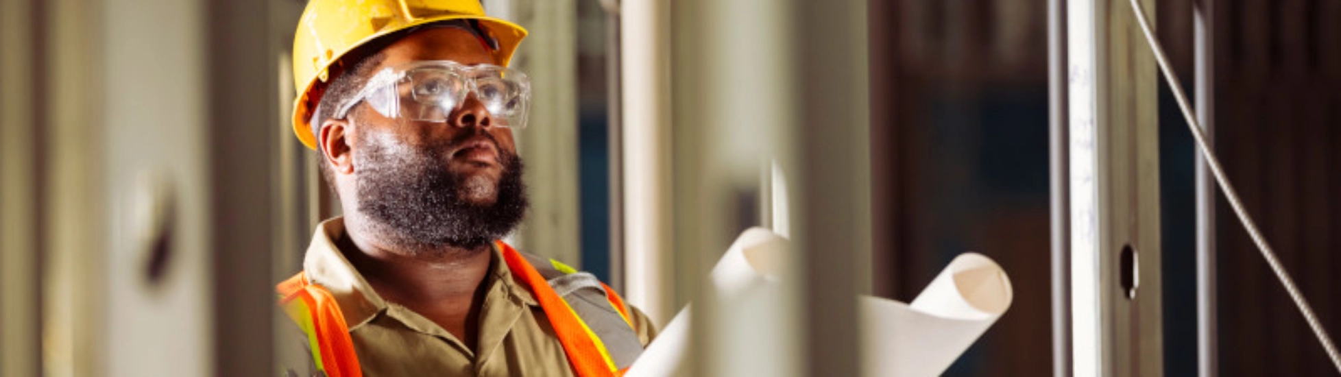 Construction worker reviewing drawings