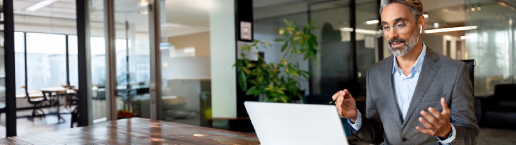 middle aged man taking a business meeting from his laptop