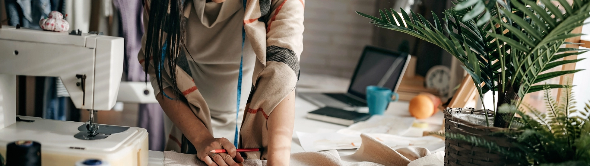 female textile worker cutting fabric seamstress