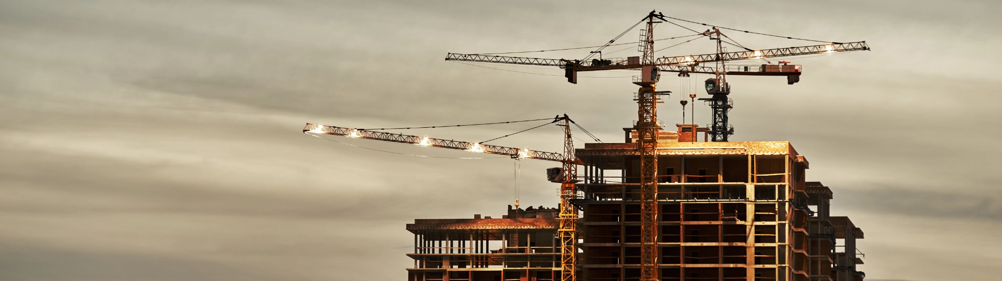 Construction site with crane at dusk