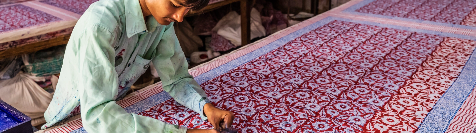 man block printing colourful fabric