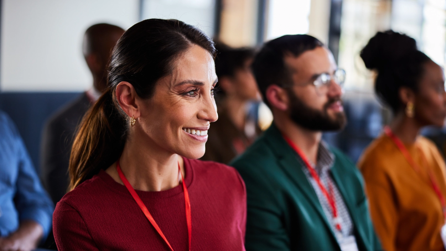 Smiling woman attending a business seminar Smiling woman attending a business seminar